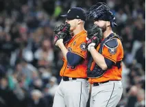  ??  ?? Houston Astros relief pitcher Ken Giles speaks to catcher Brian McCann during the eighth inning of Tuesday’s game in New York.