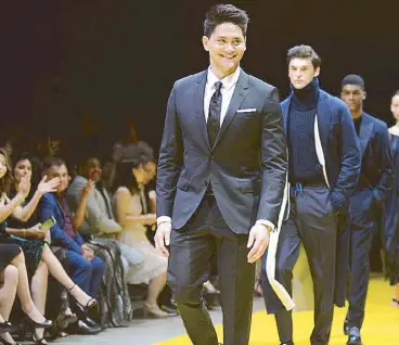  ??  ?? Catwalk debut: Olympic gold-medal swimmer Joseph Schooling leads 45 models down the runway during the finale of the Boss fashion show at the Marina Bay Sands Expo and Convention Centre.
