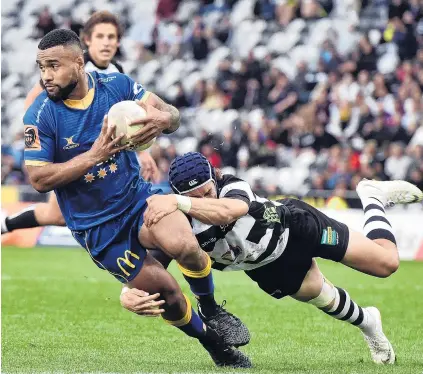  ?? PHOTO: PETER MCINTOSH ?? Not quite away . . . Otago winger Joan Nareki is tackled by Hawke’s Bay replacemen­t back Caleb Makene during the Ranfurly Shield match at Forsyth Barr Stadium in Dunedin yesterday.