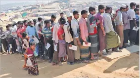  ??  ?? REUTERS Rohingya refugees stand in a queue to collect aid supplies in Kutupalong refugee camp in Cox’s Bazar, Bangladesh, on January 21, 2018.