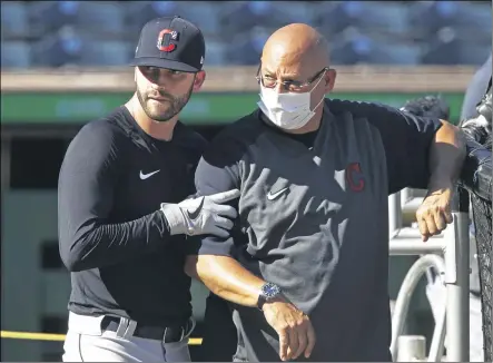  ?? GENE J. PUSKAR — THE ASSOCIATED PRESS ?? The Indians’ Tyler Naquin, left, squeezes past manager Terry Francona during batting practice before an exhibition game against the Pirates July 18 in Pittsburgh.