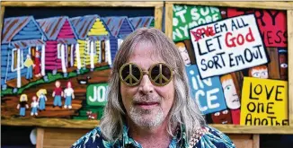  ?? CONTRIBUTE­D BY KRISTIN DAVIS ?? Artist Sam Granger, better known as “World Famous SamG,” shows off his quirky kingdom of outsider art. His self-portraits usually feature peace symbols on sunglasses.