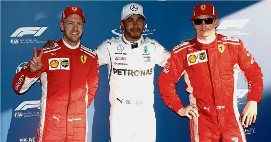  ?? — Reuters ?? Blazing on: Mercedes’ Lewis Hamilton (centre) celebratin­g his pole position with Ferrari’s Sebastian Vettel (left) and Kimi Raikkonen at the Australian Grand Prix yesterday.