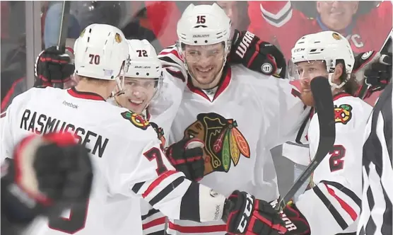  ?? | BRUCE BENNETT/ GETTY IMAGES ?? Hawks center Artem Anisimov ( 15) celebrates his winning goal in overtime Friday against the Devils.