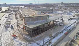  ?? MIKE DE SISTI AND JIM NELSON / MILWAUKEE JOURNAL SENTINEL ?? Work continues last week on the future Komatsu Mining
Corp. facility in Milwaukee’s Harbor District on the former Milwaukee Solvay Coke Co. property site, 311 E. Greenfield
Ave.