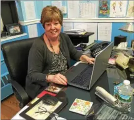  ?? PEG DEGRASSA — DIGITAL FIRST MEDIA ?? Principal Barbara Burke sits at the desk in her office at Saint James Regional Catholic School, 500 Tome St., Ridley Park. Burke is in her second year as principal there, previously serving as principal at St. Mary Magdalen Elementary School in Upper...