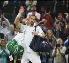  ?? Associated Press ?? Britain’s Andy Murray waves after losing the singles tennis match against John Isner of the US on day three of the Wimbledon tennis championsh­ips in London on Wednesday.