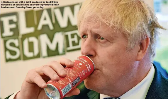  ?? ?? > Boris Johnson with a drink produced by Cardiff firm Flawsome! at a stall during an event to promote British businesses at Downing Street yesterday