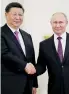  ??  ?? Russian President Vladimir Putin greets Chinese President Xi Jinping at the Kremlin