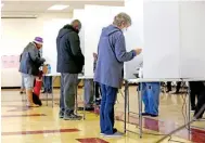  ?? FRED SQUILLANTE/COLUMBUS DISPATCH ?? People vote on Tuesday at Linden Community Center. A long line at the 6:30 a.m. start was reported.