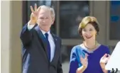  ?? AP PHOTO/DAVID J. PHILLIP ?? Former President George W. Bush, accompanie­d by his wife, former first lady Laura Bush, flashes the “W” sign in 2013. The former president will speak at the Athens Area Chamber of Commerce benefit set for June 2019.