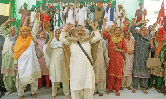  ?? Photo: ANI ?? Women farmers raise slogans during a protest against the new farm laws, at the Singhu border in New Delhi, India on February 24, 2021.