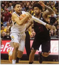  ?? AP/L.G. PATTERSON ?? Missouri’s Kassius Robertson (left) dribbles past Arkansas’ Anton Beard during the Tigers’ 77-67 victory Saturday. With the SEC Tournament in St. Louis, Missouri is playing two hours from its campus in Columbia and hopes to get a boost from fans at the...