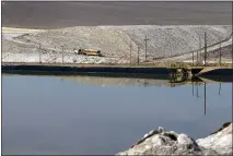  ?? TEVE MARCUS — LAS VEGAS SUN VIA AP, FILE ?? A truck carries away waste salt at the Silver Peak lithium mine near Tonopah, Nev., on Jan. 20, 2017.