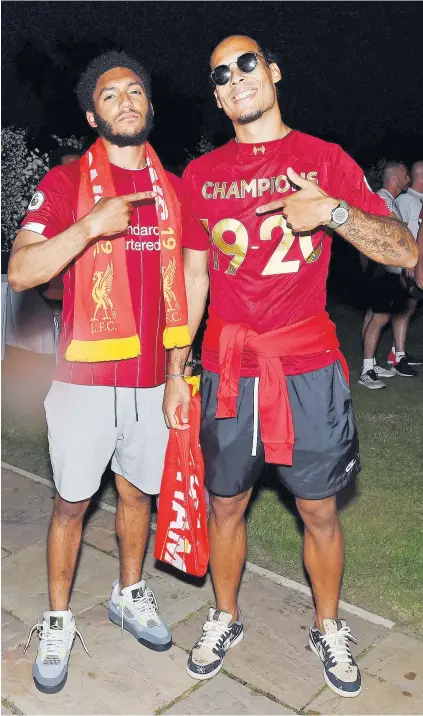  ??  ?? Champion feeling: Defenders Joe Gomez (left) and Virgil van Dijk celebrate winning the Premier League following Manchester City’s defeat by Chelsea, while goalkeeper Alisson Becker (far right) keeps the party, held at Formby Hall, going long into the night