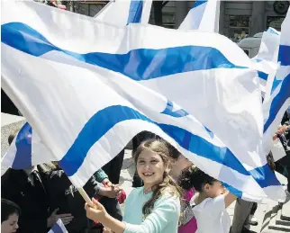  ?? PIERRE OBENDRAUF ?? Ten-year-old Lilah Goodman was among those at Phillips Square on Tuesday. Hundreds of students from Jewish schools across Montreal were on hand for the rally to celebrate Israeli Independen­ce Day.