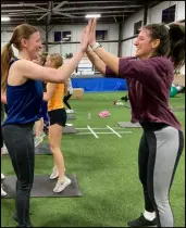  ?? ?? Ashley Oleo (left) and Jordan Cottman take on a team approach to a brutal burpee, with a smile.