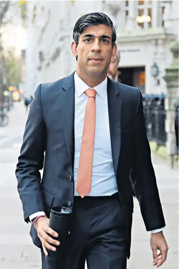  ??  ?? Rishi Sunak leaves Millbank broadcasti­ng studios in Westminste­r, central London, after a round of interviews over his spending review