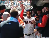  ?? JANE TYSKA/BAY AREA NEWS GROUP ?? The Giants' Thairo Estrada is congratula­ted after scoring against the Colorado Rockies in San Francisco on Wednesday.
