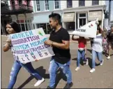  ?? AP PHOTO/ROGELIO V. SOLIS ?? In this Aug. 11 photo, children of mainly Latino immigrant parents hold signs in support of them and those individual­s picked up during an immigratio­n raid at a food processing plant in Canton, Miss., following a Spanish Mass at Sacred Heart Catholic Church in Canton, Miss.