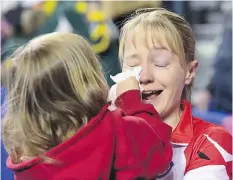 ??  ?? Kali, 3, daughter of Team Canada third Amy Nixon, wipes her mother’s tears following a 7-4 win over Northern Ontario on Sunday in the bronze medal game at the Scotties Tournament of Hearts in St. Catharines, Ont.