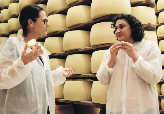  ?? NETFLIX ?? Samin Nosrat, right, stars in Netflix’s new cooking documentar­y series Salt, Fat, Acid, Heat, which features more women than many other travel cooking shows.