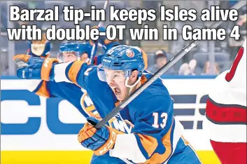  ?? Michelle Farsi ?? MAT’S ALL, FOLKS: An exuberant Mathew Barzal celebrates after he tips in the puck for the game-winning goal in double-overtime Saturday afternoon to beat the Hurricanes.