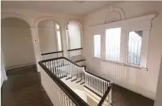  ?? Courtesy photo ?? The stair rail and secondfloo­r landing in the Neuhaus Home have hardwood floors and decorative woodwork around windows and doorways.