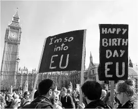  ??  ?? Demonstrat­ors hold a banner in Parliament Square, London, as they take part in a ‘Unite for Europe’ march on Saturday