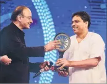  ??  ?? ▪ Acharya Balkrishna, managing director of Patanjali Ayurved Ltd, receives the Indian of the Year award in the business category.