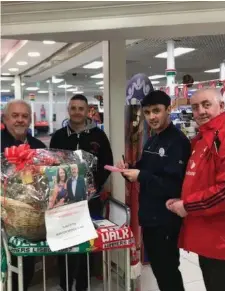  ??  ?? The Sligo Branch Of Liverpool Supporters Clubs has been raising money for the Sean Cox Medical Appeal. A Christmas hamper was raffled in Tesco Arcade and €1,500 was raised. Micky McTiernan and Secretary Steve Taylor are pictured choosing the lucky winner, Ann Johnston from Sligo