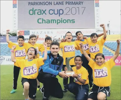  ??  ?? Parkinson Lane Primary are presented with the trophy from Yorkshire CCC’s Will Rhodes.