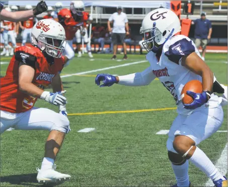  ?? Pete Paguaga / Hearst Connecticu­t Media ?? Connecticu­t’s Chris Chance of West Haven looks to pick up extra yards against Rhode Island during Saturday’s Governor’s Cup in New Britain.