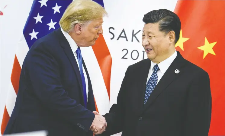  ?? BRENDAN SMIALOWSKI / AFP / GETTY IMAGES ?? U.S. President Donald Trump and Chinese counterpar­t Xi Jinping, shown at the G20 Summit in Osaka, Japan in 2019, each slapped tariffs on goods from the other’s country.