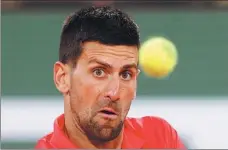  ?? REUTERS ?? Serbia’s Novak Djokovic eyes a shot during his French Open firstround victory over Japan’s Yoshihito Nishioka on Monday.