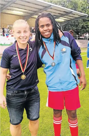  ?? Picture:SUPPLIED ?? LEARNING CURVE: Andisiwe Ndesi with a German soccer player at the Meppen Field after the they were defeated 6-1