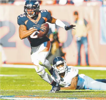  ?? Joe Amon, The Denver Post ?? Broncos cornerback Chris Harris takes off after making an intercepti­on Sunday against the Tennessee Titans.