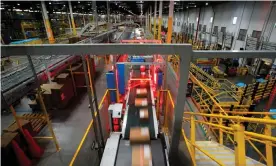  ?? ?? A fast-moving conveyor moves packages through a scanning machine on their way to delivery trucks at Amazon's fulfillmen­t center in Robbinsvil­le, New Jersey. Photograph: Mike Segar/Reuters