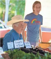  ?? CHERYL EVANS/THE REPUBLIC ?? Frank Martin, left, and Ron Lamb, from Crooked Sky Farms, sell produce at Gilbert Farmers Market on Sept. 16, 2017. Martin has leased the farm’s current location since 2003.