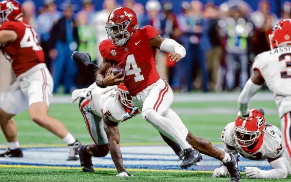  ?? Todd Kirkland/Getty Images ?? Jalen Milroe’s miracle 4th-and-31 touchdown pass to beat Auburn, along with beating Georgia for the SEC title, likely influenced the College Football Playoff committee to give one-loss Alabama the fourth playoff spot over undefeated Florida State.