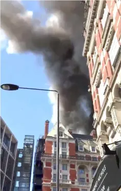  ??  ?? Still image obtained from a video by social media shows a blaze at the Mandarin Oriental Hotel in Knightsbri­dge, London. — Reuters photo