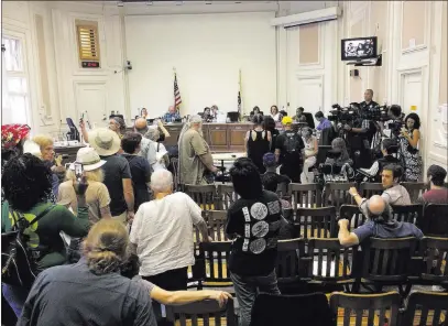  ?? Paul Elias ?? The Associated Press Dozens of people line up Tuesday in Berkeley, Calif., to tell the City Council what they think of a police request to use pepper spray on violent crowds. Most residents opposed the request.