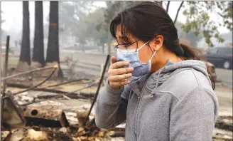  ?? Associated Press photos ?? Leslie Garnica, 17, cries while recalling the fire which destroyed her family home in the Coffey Park area of Santa Rosa, Calif., on Tuesday. An onslaught of wildfires across a wide swath of Northern California broke out almost simultaneo­usly then grew...