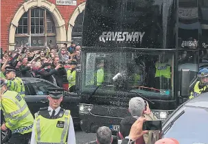  ??  ?? A beer can is hurled at the Manchester United bus as it arrives at the ground