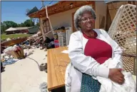  ?? Rogelio V. Solis/Associated Press ?? After the Storm: Mattie Coleman, laughs outside what remains of her combinatio­n flower shop, thrift store and laundromat facility Monday in Durant, Miss., as she cleans up from a possible tornado hit on Sunday morning.