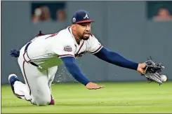  ?? John Bazemore / The Associated Press ?? Atlanta left fielder Matt Kemp makes a diving attempt for a ball hit by Toronto’s Luke Maile in the fourth inning Wednesday’s game in Atlanta.