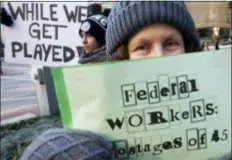  ?? MICHAEL DWYER - THE ASSOCIATED PRESS ?? Esther Anastasia holds a sign during a protest rally with government workers and their supporters in Boston, Friday. The workers rallied with Democratic U.S. Sen. Ed Markey and other supporters to urge that President Donald Trump put an end to the shutdown so they can get back to work.