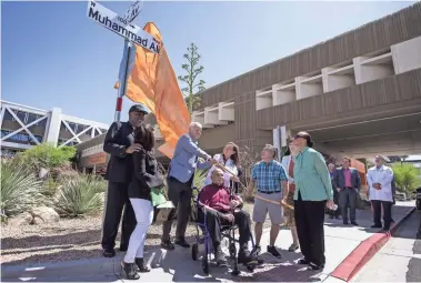  ?? PHOTOS BY SEAN LOGAN/THE REPUBLIC ?? A street sign for the newly named Muhammad Ali Way is unveiled on Monday at Barrow Neurologic­al Institute in Phoenix.