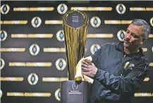  ??  ?? Charley Green buffs the NCAA college football championsh­ip trophy Jan. 7 in Atlanta. The College Football Playoff selection committee began its fifth season Tuesday. The usefulness of the committee’s work and the nationally televised reveal is debatable. But what if anything can be learned from the first four years of CFP rankings? Of the 16 teams the committee ranked in the top four of its initial rankings from 2014-17, half made the playoff.