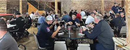  ?? (Staff photo by Sharda James) ?? First responders enjoy lunch provided by Big Jake’s BBQ on Wednesday, May 24, 2023, at Crossties in downtown Texarkana, Arkansas, during the eighth annual EMS Appreciati­on Day event.